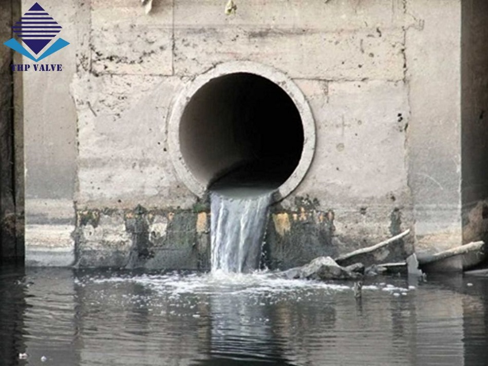 a water coming out of a concrete tunnel